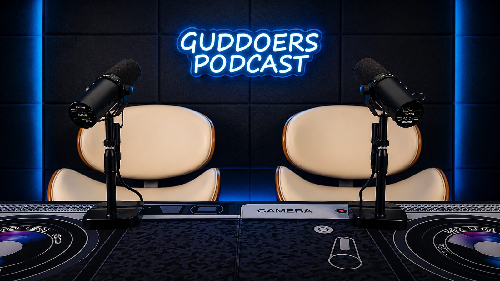 The Guddoers Podcast studio with two microphones and the neon Guddoers Podcast sign